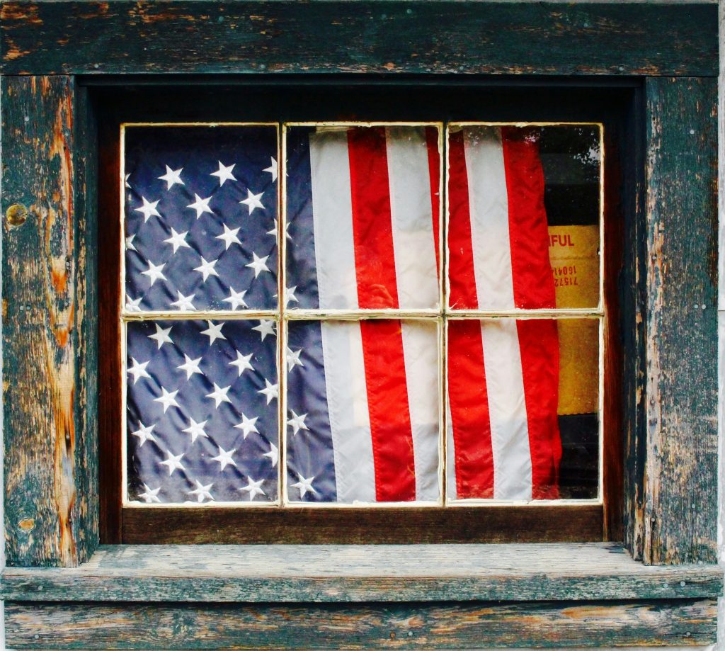 American Flag in Window | Becraft Guide on Becoming a U.S. Citizen | Law Office of Todd Becraft